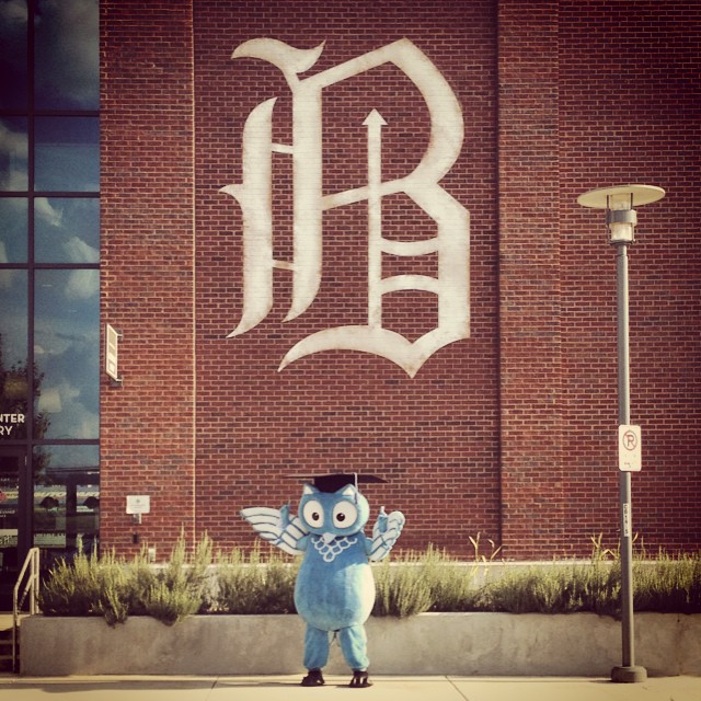 ProctorU mascot in front of Birmingham Barons B. 