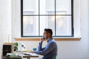 man in window at computer